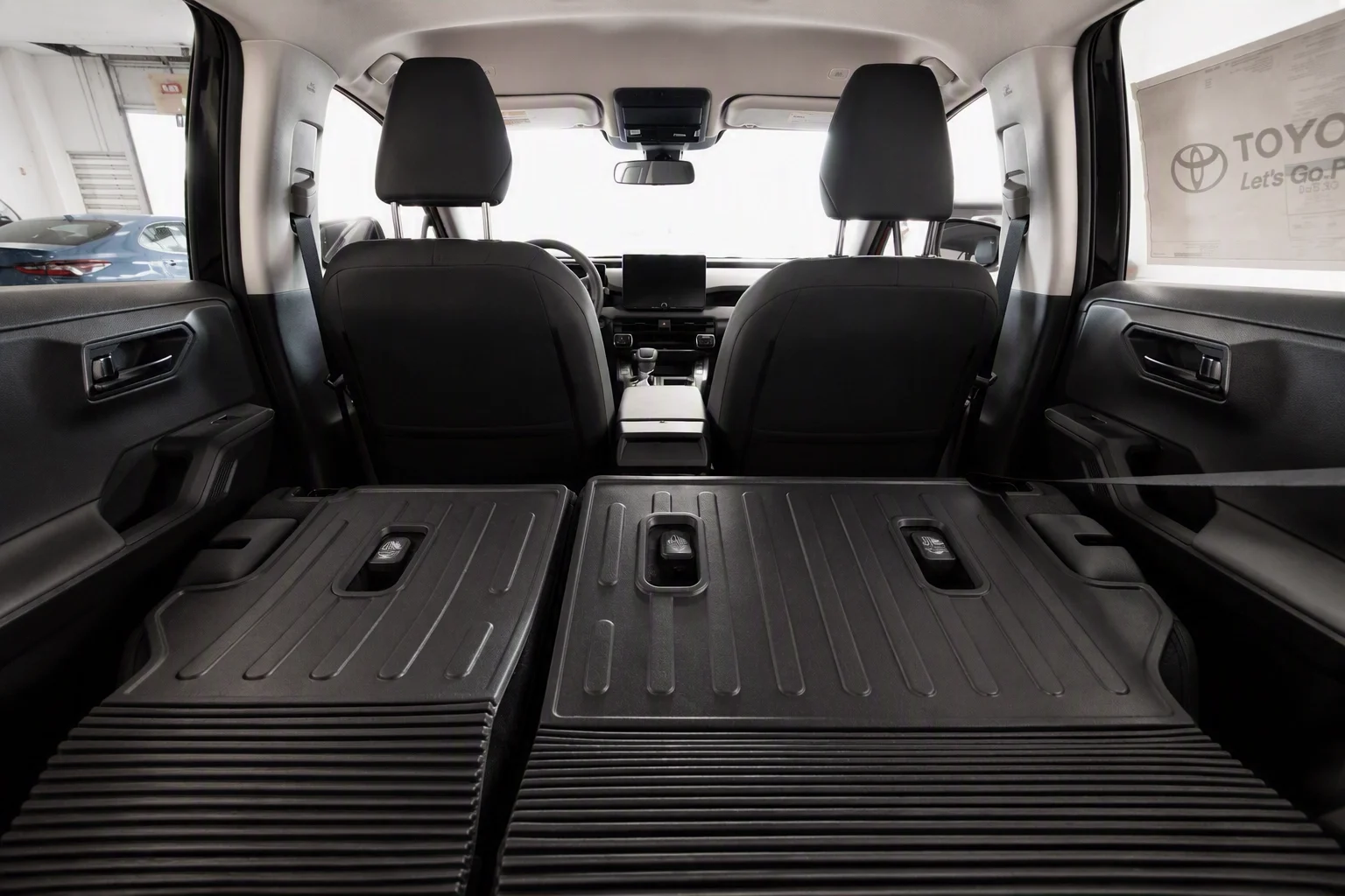 2026 Toyota RAV4 LE cargo area with the rear seats folded flat at Sloane Toyota of Philadelphia